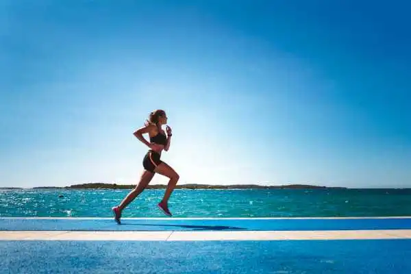 Woman running showing strong leg muscle Henley-on-Thames